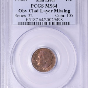 May include: A 1994-D dime coin with a mint error, graded PCGS MS64, in a protective case. The coin's obverse side features a portrait and the inscription "IN GOD WE TRUST". The case includes a label with details about the coin.