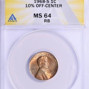 May include: A 1968-S 1C MS 64 RB penny coin, encapsulated in a clear plastic holder. The coin is off-center by 10% and graded MS 64 by ANACS. The coin features a portrait and the year 1968.