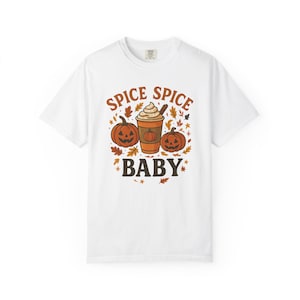 May include: White t-shirt with a fall-themed graphic. The design features two carved pumpkins, a coffee drink, and autumn leaves. The text "SPICE SPICE BABY" is printed above and below the central image.