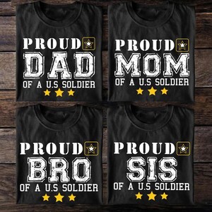 May include: Four black t-shirts with white text that reads "PROUD DAD OF A U.S SOLDIER", "PROUD MOM OF A U.S SOLDIER", "PROUD BRO OF A U.S SOLDIER", and "PROUD SIS OF A U.S SOLDIER". Each shirt has a star graphic.