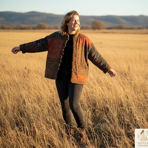 May include: A patchwork jacket with a leopard print, orange, and brown design. The jacket has a button-up front and is worn by a person in a field of tall grass. The jacket is a mix of textures and colours, creating a unique and stylish look.