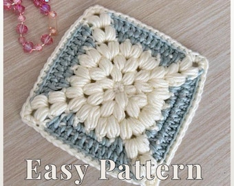 May include: A square crochet pattern in cream and light blue, with the text "Crochet Pattern PDF", "Easy Pattern", and "Beginner Friendly". The central design features a flower-like pattern. The crochet work is detailed and textured.