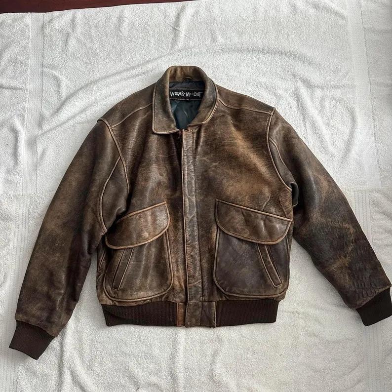 Back view of distressed brown leather bomber jacket showing natural texture and worn-in vintage finish — handmade real leather outerwear.