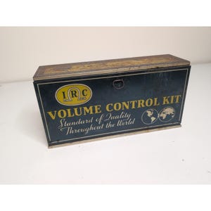May include: Vintage metal box with the text "VOLUME CONTROL KIT" in gold lettering. The box is dark blue with a gold trim and a small handle. The text "Standard of Quality Throughout the World" is also displayed.