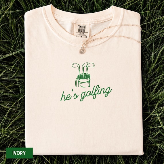 Comfort Colors® He's Golfing Shirt, Golfing Season Shirt, Golfer Wife Shirt, Golfing Mom Shirt, Golf Player Shirt for Mom, Golf Lover Shirt
