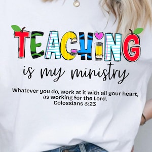 May include: White t-shirt with the words "TEACHING is my ministry" in colorful, playful lettering. The shirt also features the Bible verse Colossians 3:23. A casual and inspirational design.
