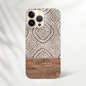 May include: A white and brown patterned phone case with a wood grain design on the bottom. The case is designed for an iPhone.