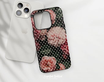 May include: A black phone case with a floral design featuring pink and red roses on a black background with white polka dots. The text "Sugarleaf Boutique" is printed on the bottom of the case.