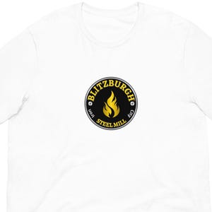 May include: White t-shirt featuring a circular logo with the text "BLITZBURGH IRON STEEL MILL CITY" around a yellow flame on a black background. The shirt is made of a soft, comfortable material.