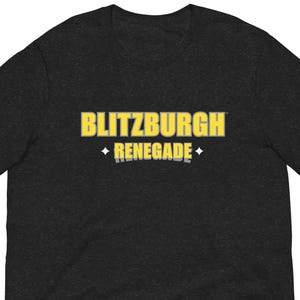 May include: Dark gray t-shirt with the text "BLITZBURGH RENEGADE" in yellow and white. The text is centered on the chest of the shirt. The shirt is short-sleeved and appears to be made of a soft material.