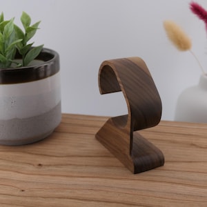 May include: A set of three ceramic mugs with a speckled, matte finish in cream, light grey, and dark grey. Each mug has a simple, minimalist design, ideal for coffee or tea.
