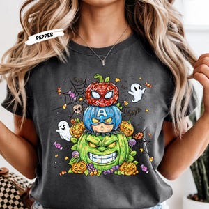 Get ready to turn heads this Halloween with our Stacked Superhero Pumpkin Shirt! 🎃💥 This fun and spooky fall tee features your favorite Marvel-inspired heroes — Spider-Man, Captain America, and Hulk — as adorable carved pumpkins stacked high in festive Halloween flair! 👻🕸️
