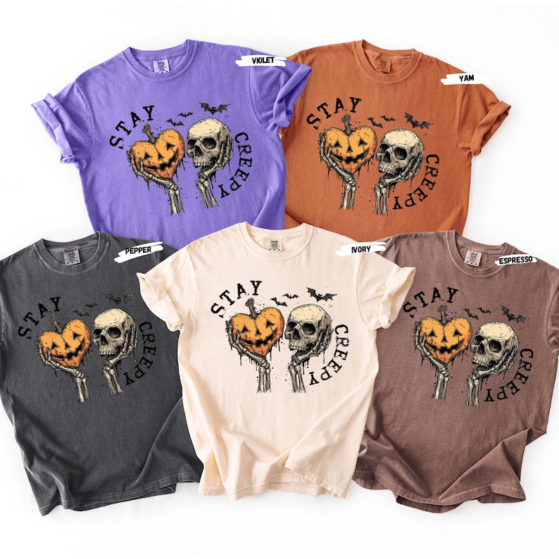 Stay spooky in style with this bold Stay Creepy Halloween Shirt featuring a haunting skull and melting jack-o’-lantern heart design. Perfect for lovers of gothic fashion, spooky season vibes, and creepy cute aesthetics, this skull and pumpkin tee is the ultimate Halloween staple.