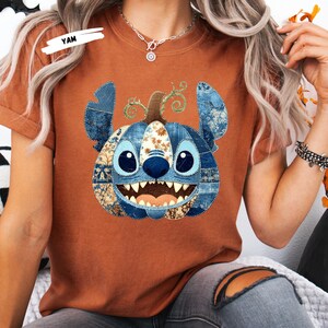 🎃 Cozy Disney Halloween Sweatshirt – Patchwork Stitch Pumpkin Pullover
Celebrate spooky season in magical style with this adorable Stitch pumpkin sweatshirt, featuring a patchwork pumpkin design in rich denim and floral patterns. Perfect for Disney Halloween outfits, fall trips to the parks, or cozy autumn nights. This unisex crewneck makes the ultimate gift for Disney lovers, pumpkin spice fans, and anyone who loves cute and spooky fashion. Soft, comfortable, and perfect for Halloween parties