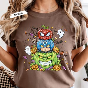 Get ready to turn heads this Halloween with our Stacked Superhero Pumpkin Shirt! 🎃💥 This fun and spooky fall tee features your favorite Marvel-inspired heroes — Spider-Man, Captain America, and Hulk — as adorable carved pumpkins stacked high in festive Halloween flair! 👻🕸️