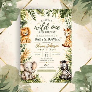 May include: A baby shower invitation card featuring watercolour illustrations of a lion, giraffe, elephant, and zebra surrounded by tropical leaves. Text reads: A LITTLE wild one IS ON THE WAY! PLEASE JOIN US FOR A BABY SHOWER HONOURING Olivia Johnson.