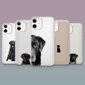 May include: A selection of phone cases with black Labrador Retriever dog designs. The cases display different images of the dogs, including full body portraits, close-ups, and silhouettes. The cases are in clear, beige, and white colours.