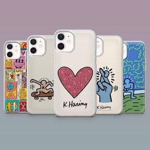 May include: A collection of five phone cases featuring colorful pop art designs. The cases showcase various illustrations, including a heart, a skateboarder, and a hand with crossed fingers, all in a vibrant, graphic style. Each case has the artist's signature.