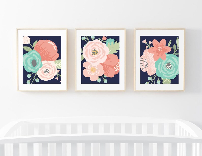 May include: Three framed prints with floral designs on a navy blue background. The flowers are in shades of pink, coral, and teal.
