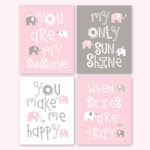 May include: Set of four pink and gray nursery prints with elephant illustrations and text that reads "You are my sunshine", "My only sunshine", "You make me happy", and "When skies are gray".