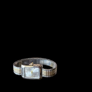 May include: A rectangular wristwatch featuring a silver-tone case and a two-tone expansion band with silver and gold-colored links. The watch face is silver with black numerals and gold-colored hands, displaying the text "my choice" at the top.