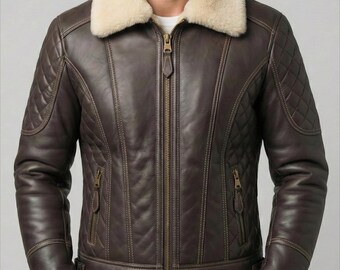 May include: A brown leather jacket with a cream-colored shearling collar and cuffs. The jacket features a front zipper, two zippered pockets, and quilted shoulder and arm details. The jacket is a classic style.