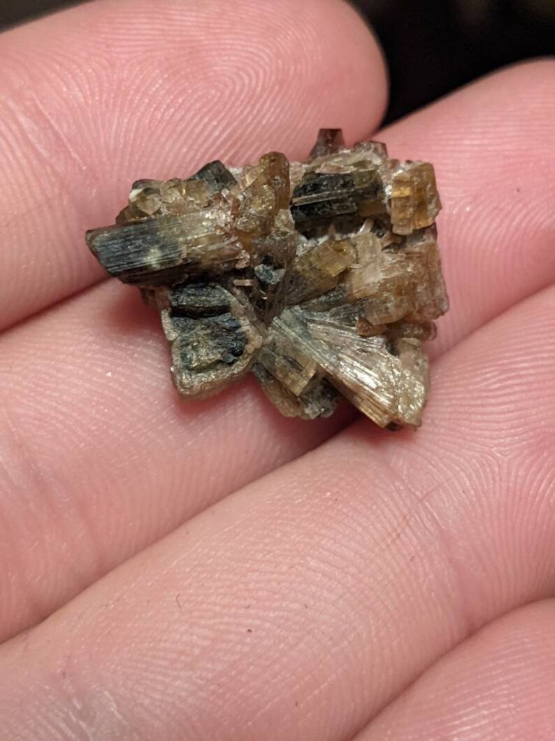 May include: A cluster of brown and green crystals with a rough, natural texture.