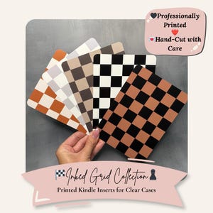 May include: A hand holds a fan of printed Kindle inserts with checkerboard patterns in various colors: orange and white, gray and white, brown and gray, black and white, and brown and black. The text reads "Inked Grid Collection" and "Printed Kindle Inserts for Clear Cases."