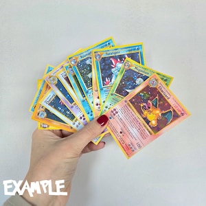 Ascended Heroes card example showing Pokémon cards used to demonstrate how the master set fits into a collector’s binder.