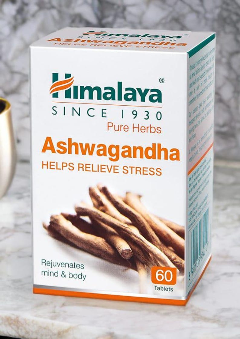 May include: A white box of Himalaya Ashwagandha tablets. The box features the Himalaya logo and the text "SINCE 1930 Pure Herbs." The box also states "HELPS RELIEVE STRESS" and "Rejuvenates mind & body." The box contains 60 tablets.