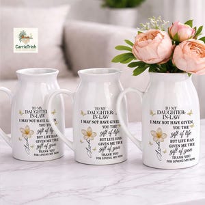 May include: A set of three ceramic nesting bowls in graduating sizes. The bowls feature a speckled, off-white glaze with a slightly textured surface. Each bowl has a rounded shape and a simple, minimalist design.