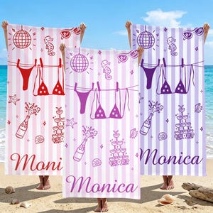May include: Beach towels with a vertical striped pattern in pink and purple. Each towel features a bikini, disco ball, champagne bottle, and the name "Moni" or "Monica". The towels are held up against a beach backdrop.