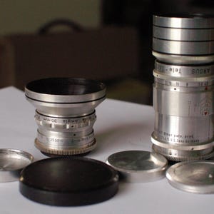 Argus C3 C2 Mount 100mm f4.5 Tele-Sandmar and 35mm f4.5 Sandmar Wide lenses with hoods and caps. Excellent condition.  Made in Germany.