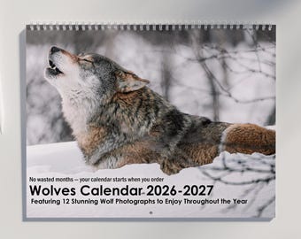 May include: A spiral-bound calendar featuring a howling wolf in a snowy landscape. The calendar is titled "Wolves Calendar 2026-2027" and includes the text "Featuring 12 Stunning Wolf Photographs to Enjoy Throughout the Year."