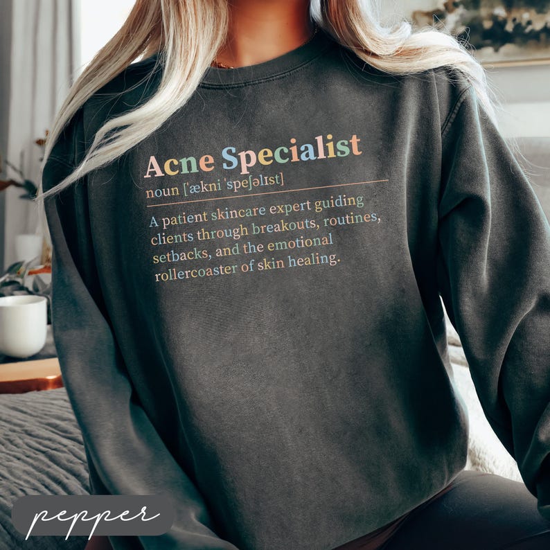 A graphic on a sweatshirt defining "Acne Specialist" with colorful text.