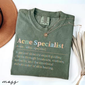 Green t-shirt with "Acne Specialist" definition and skincare advice.