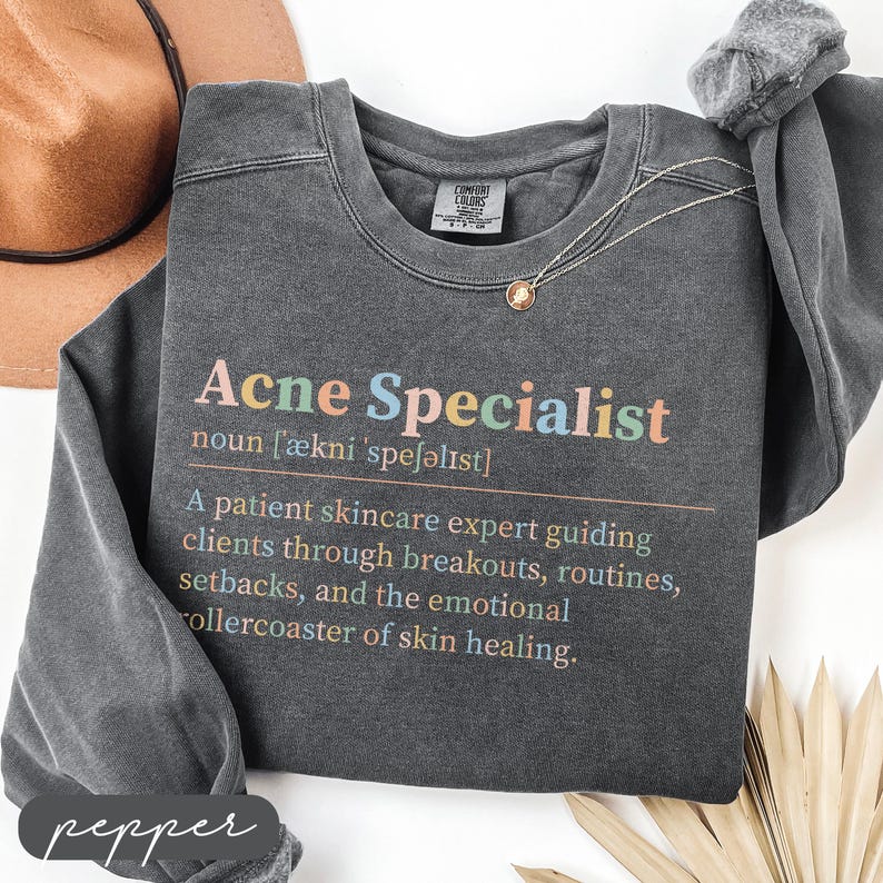 Dark grey sweatshirt with "Acne Specialist" text and definition.