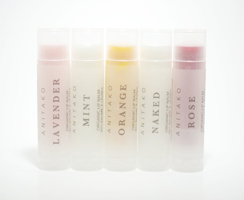 May include: Five different flavored organic lip balms in clear tubes with frosted labels. The flavors are Lavender, Mint, Orange, Naked, and Rose.