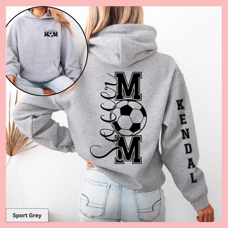 May include: Sport grey hoodie with "Soccer Mom" printed on the front and back. The back features a soccer ball graphic and the name "Kendal" on the sleeve. The front has the text "Soccer Mom" in a smaller font.