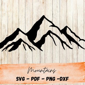 May include: Black mountain range silhouette design on a light wood grain background. The word "Mountains" is written in cursive on an orange watercolor banner. Below the banner are the file types: SVG - PDF - PNG - DXF.