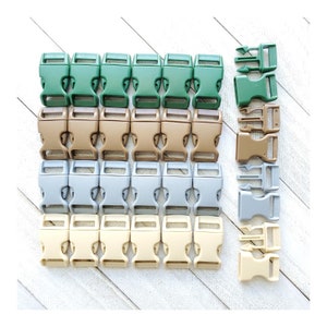 May include: Assortment of plastic side release buckles in green, brown, gray, and beige. The buckles are arranged in rows and are all the same size.