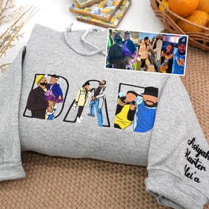 Sport Gray embroidered hoodie featuring “DAD” letters filled with colorful illustrations of dad with children, based on customer family photo. Sleeve personalized with kids’ names. Unique Father’s Day gift, birthday gift, or custom keepsake sweatshirt for dads.
