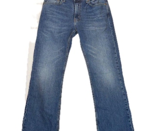May include: A pair of blue denim jeans featuring a classic five-pocket design, a button fly closure, and a straight-leg cut. The fabric displays a medium wash with subtle fading on the thighs and knees, finished with copper-toned rivets.