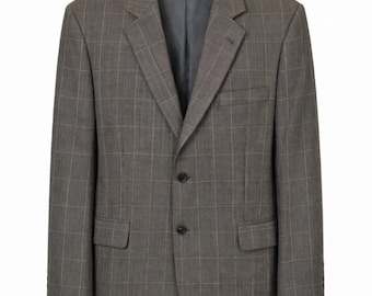 May include: A grey blazer featuring a subtle brown windowpane check pattern, a notched lapel, two black front buttons, two flap pockets, and a chest pocket. The interior is lined with a solid grey fabric and includes a visible brand label.
