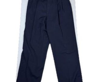 May include: A pair of dark navy blue trousers featuring a pleated front design, a button and zipper fly closure, and a structured waistband with belt loops. The pants have a straight-leg cut and a clean, solid-colored finish throughout.