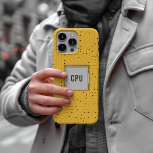 May include: Yellow phone case with a circuit board design and a CPU graphic. The case has a rectangular CPU graphic with the word "CPU" in the center. The phone case is held by a person.