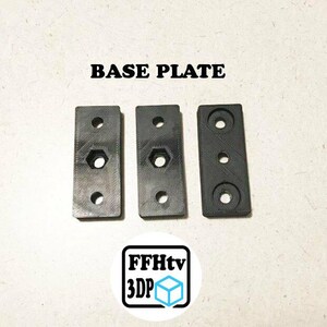 May include: Three rectangular black base plates with pre-drilled holes. Two plates feature a central hexagonal cutout, while the third has a circular center hole. The text BASE PLATE is printed above, and a logo with FFHtv 3DP is below.
