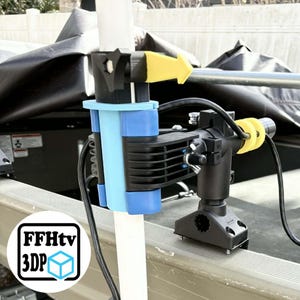May include: A black and blue boat accessory with a yellow arrow and the text "FFHtv 3DP". The accessory is mounted on a white pole and has a black and yellow component attached. The background includes a boat and a cover.
