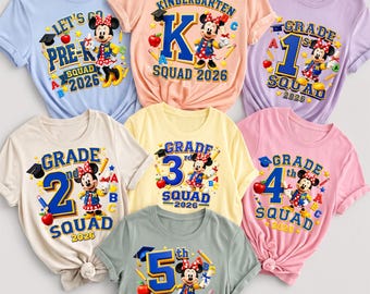 May include: Seven short-sleeved t-shirts in various pastel colors, each featuring a graphic of Minnie Mouse and text indicating school grades from Pre-K to 5th grade, along with the text Squad 2026, surrounded by school-themed icons like apples and pencils.