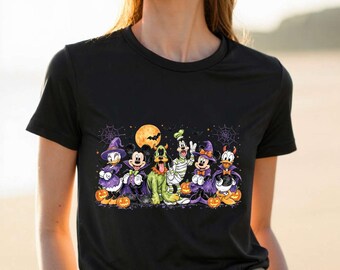 May include: A black short-sleeved t-shirt featuring a graphic print of Disney characters dressed in Halloween costumes, including Mickey and Minnie Mouse, Donald and Daisy Duck, Pluto, and Goofy, surrounded by pumpkins and spiderwebs.